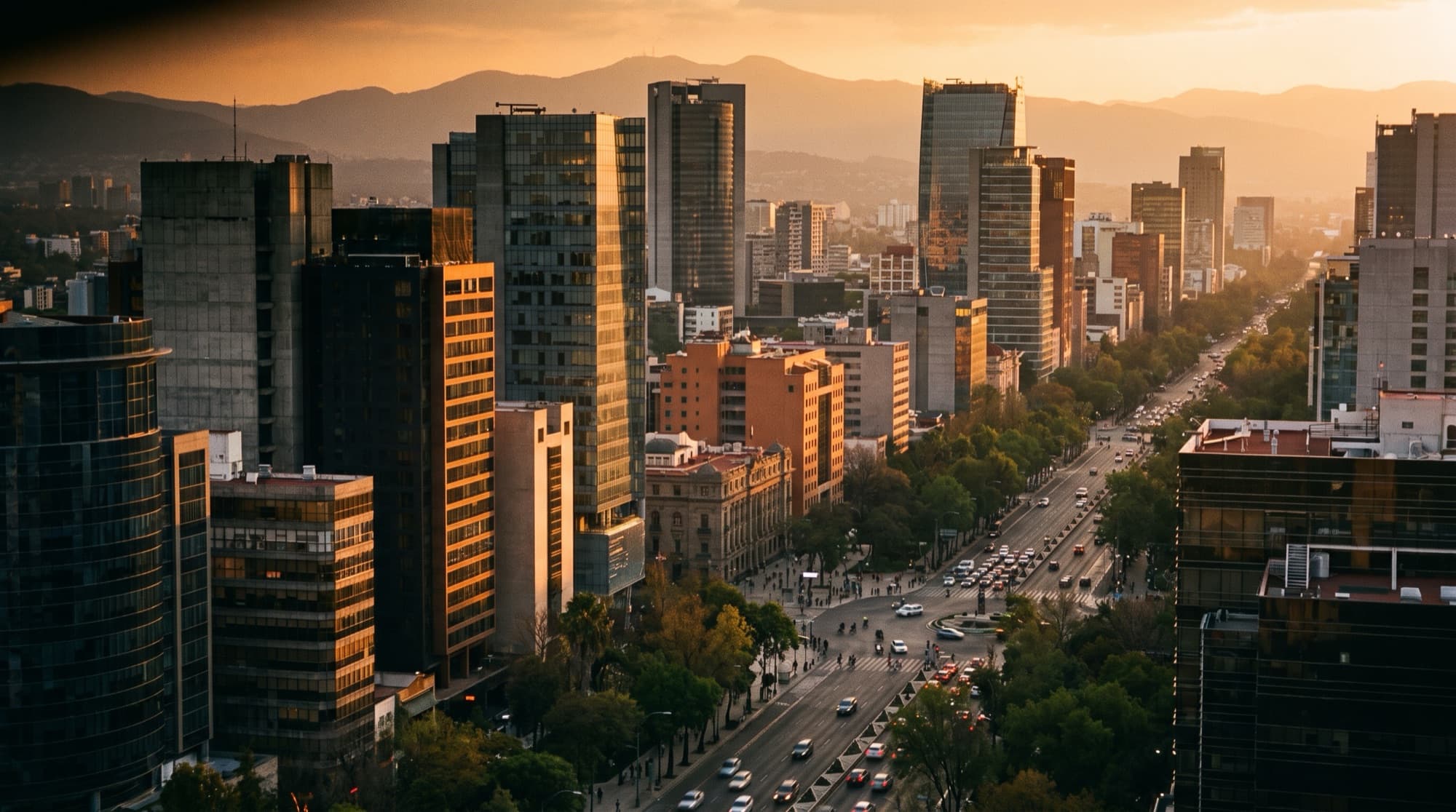 Golden-hour skyline of a modern Mexican metropolis with distant mountains