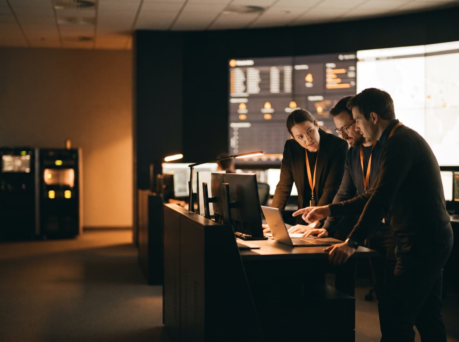 A network-operations team monitoring dashboards in a modern control room